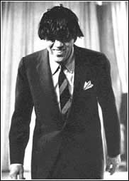 Ed Sullivan wearing a Beatles wig